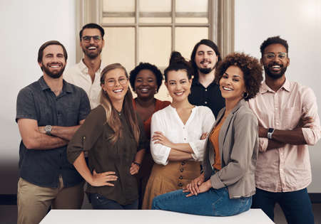 Theyre ready to push towards success with tenacity and confidence. Portrait of a group of businesspeople standing together in an office.の写真素材