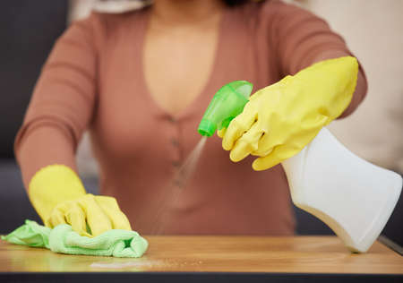 Keeping my tabletops germ-free. Cropped shot of an unrecognizable woman using detergent and a cloth...