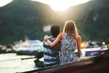 Enjoying a peaceful and perfect break together. Cropped shot of a young couple enjoying a day at the beach together.の写真素材
