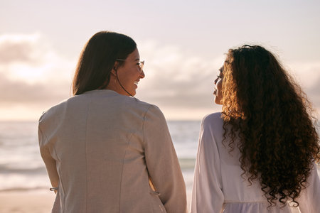 A girls beach day was needed. Shot of two best friends bonding during a day out on the beach.の写真素材