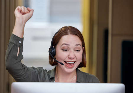 Im so glad I could help. Shot of a young call centre agent sitting alone in the office and...