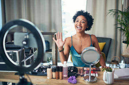 Subscribe for more beauty tips. Shot of a influencer recording a makeup tutorial for her blog at home.の写真素材