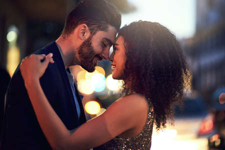 You and me against the world. Shot of a cheerful young couple holding one another while looking into...