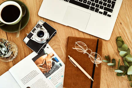Welcome to my workspace. High angle shot of technology and books on a bloggers work desk during the day.の写真素材