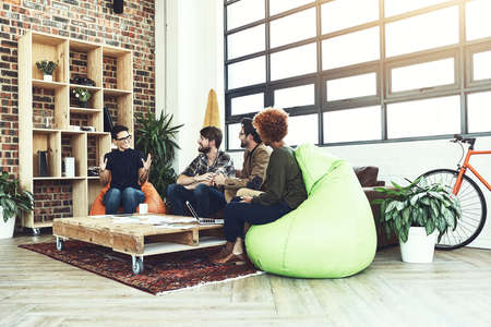 Put your ideas out there. Shot of a group of young designers having a discussion in a modern office.