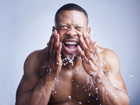 Start each day with some sk-inspiration. Studio shot of a handsome young man washing his face...