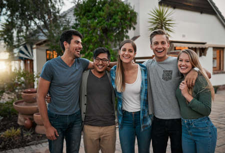 This is our gang. Portrait of a group of cheerful young friends standing together and posing for a...