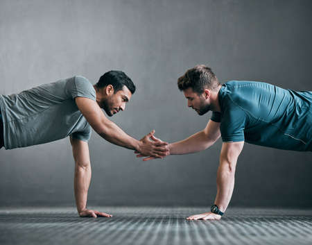 Its important to have support. Full length shot of two handsome young male athletes shaking hands...