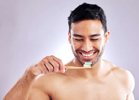 When it comes to brushing, harder isnt better. Studio shot of a handsome young man holding up his...