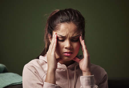 Depression can be a slippery slope. Cropped shot of an attractive young woman suffering from...
