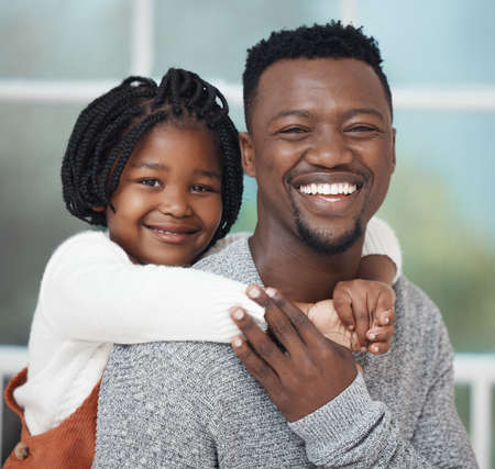 Its just my princess and I today. Shot of an adorable little girl hugging her father while bonding...