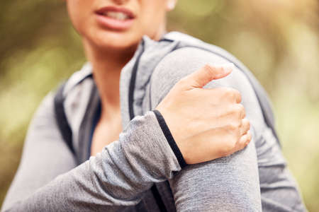 The aches and pains of improper training practices. Shot of an unrecognisable woman experiencing...