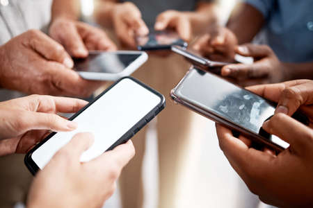Link up with like minded go getters. Shot of a group of unrecognisable businesspeople using their...