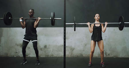 Youve got this. Shot of a young man and woman doing an overhead press with a barbell in a gym.