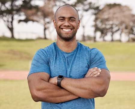 Staying fit is a lifestyle I choose. Shot of a handsome young man standing alone outside with his...