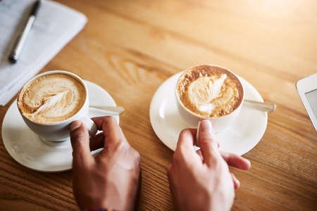 Coffee in good company. Shot of two unidentifiable men having coffee in a coffee shop.