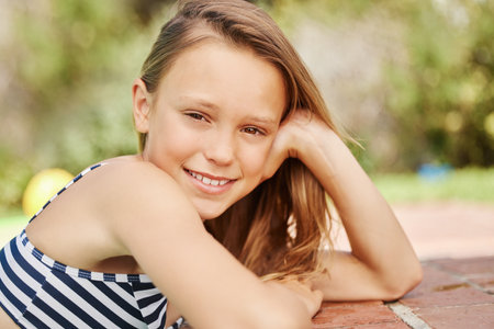 The suns out and so am I. Shot of an adorable little girl outside on a sunny day.