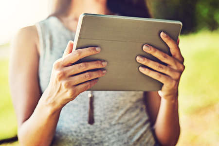 So much is going on online, I cant miss it. Closeup shot of an unrecognizable woman using a digital...