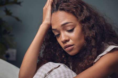 I dont know how Ill get over this. Shot of a young woman looking unhappy while sitting at home.