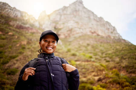 Nature called and I answered. Shot of a young woman enjoying a day in nature.の写真素材