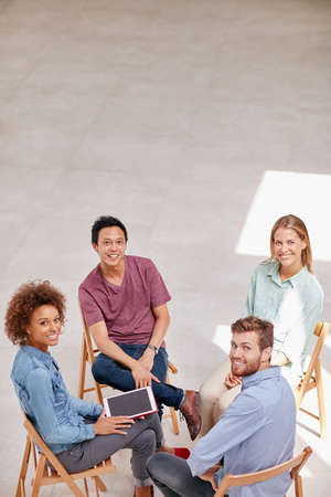 Theyre business innovators. High angle portrait of a group of businesspeople sitting together in a...