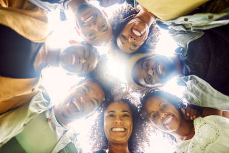 Surround you with people who get you. Cropped shot ofa group of friends looking down at the camera.