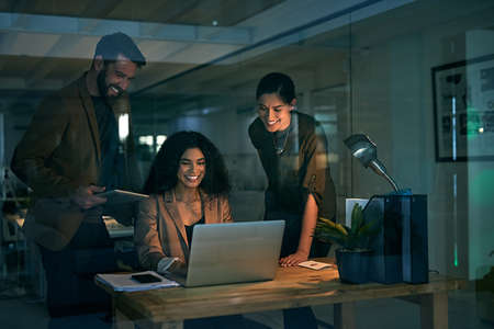 Who said success doesnt happen overnight. Cropped shot of colleagues working late.の写真素材