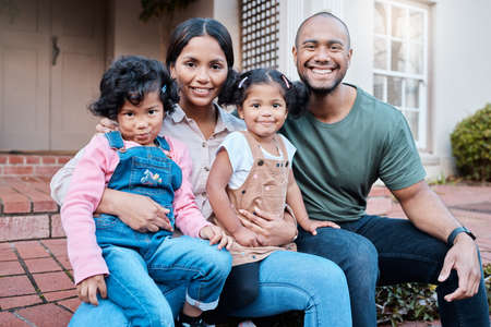 Nothing is more important than family to us. Shot of a couple spending time outside with their two daughters.の写真素材