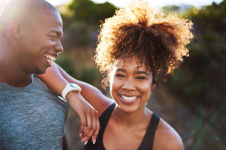 He makes me happy in so many ways. Cropped shot of a happy young couple out for a run together.の写真素材
