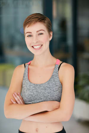 Happiness is good for your health. Portrait of a fit young woman in workout attire.の写真素材