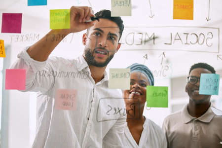 Lets do some brainstorming. Shot of businesspeople having a meeting in a boardroom at work.の写真素材