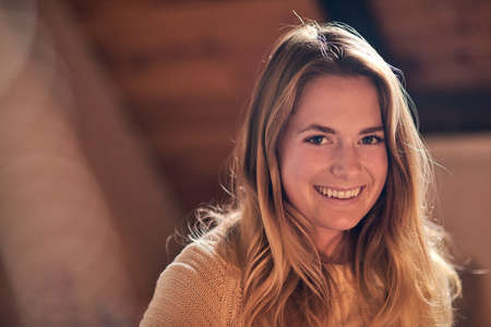 Youthful and glowing. Portrait of a pretty young woman relaxing in her bedroom at home.