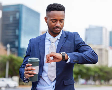 Ambition is the path to success. Shot of a confident young businessman out in the city.の写真素材
