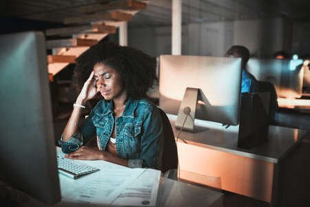 This deadline is giving her a headache. High angle shot of a young female designer looking stressed...