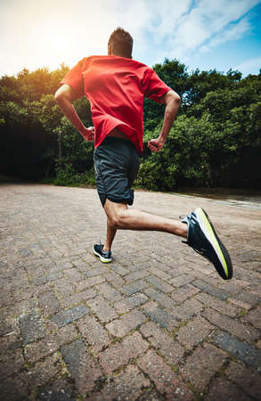 Making the most of an outdoors workout. Rearview shot of a man out for a run.