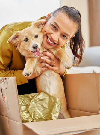 Say hello to my new baby. Shot of a young woman sitting at home with an adorable little dog.
