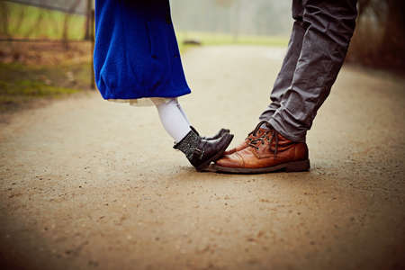 Small feet, big feet, how very sweet. Shot of an unrecognizable father and daughter outdoors.