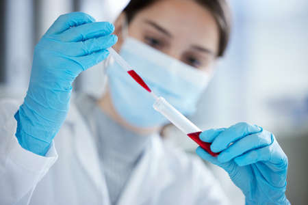 Doing multiple tests to confirm the results. Closeup shot of a young woman using a dropper and test...
