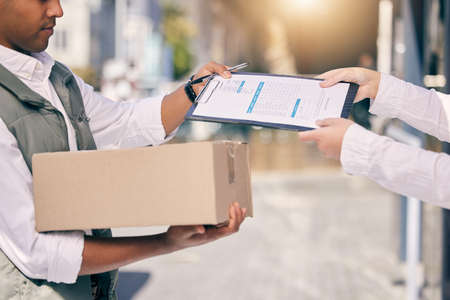 This packaged was signed for. Shot of a delivery man handing over a clipboard.の写真素材