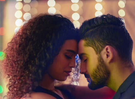 Lost in the moment. Shot of a young couple enjoying themselves at a nightclub.の写真素材