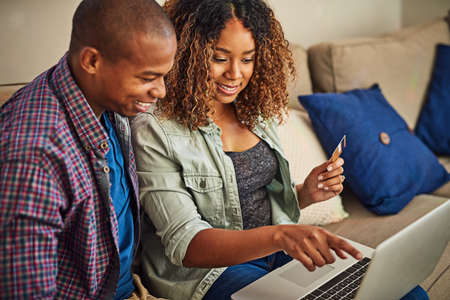 Do you think we should buy this. Shot of a cheerful young couple doing online shopping together...