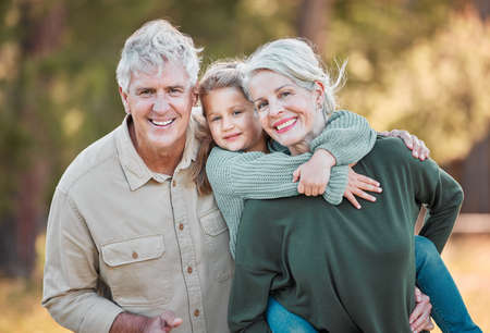 We love coming out with our grandchild. Shot of a senior couple spending time outdoors with their granddaughter.の写真素材