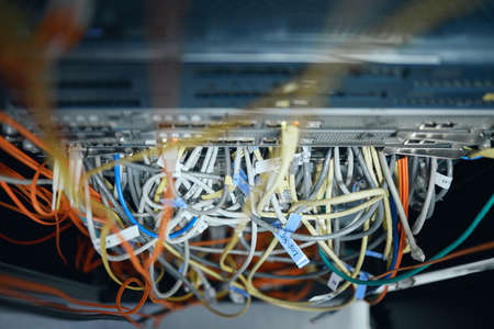 In need of some cable management. High angle shot of cables inside of a server room.の写真素材