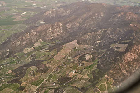 Everything is tiny from up here. High angle shot of the views from an airplane window.の写真素材