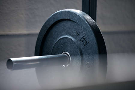 The more you lift, the lighter I get. Shot of a barbell in a gym.の写真素材