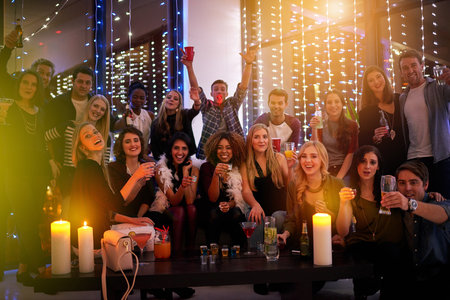 The night is young, and so are we. Shot of a large group of young people enjoying themselves at a...