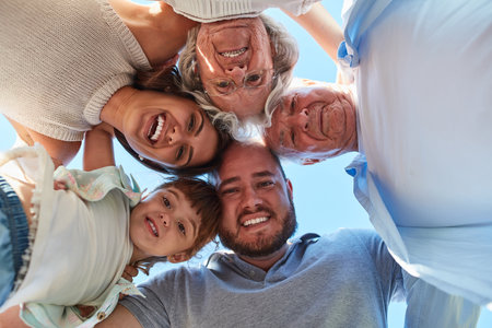 Family, the center of life. Low angle portrait of a happy three generation family huddled together...
