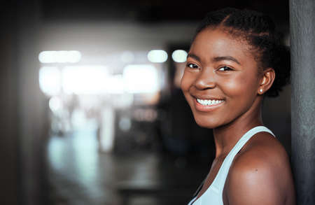 My world will be better for this. Portrait of a young beautiful woman taking a break from her workout in the gym.の写真素材