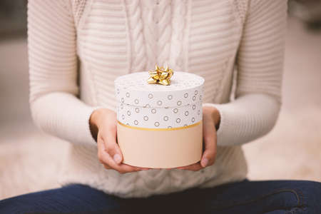 Something from me to put under your Christmas tree. Shot of an unrecognisable woman opening presents...