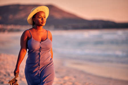 She doesnt want to be saved. Shot of a beautiful young woman enjoying alone time at the beach.の写真素材